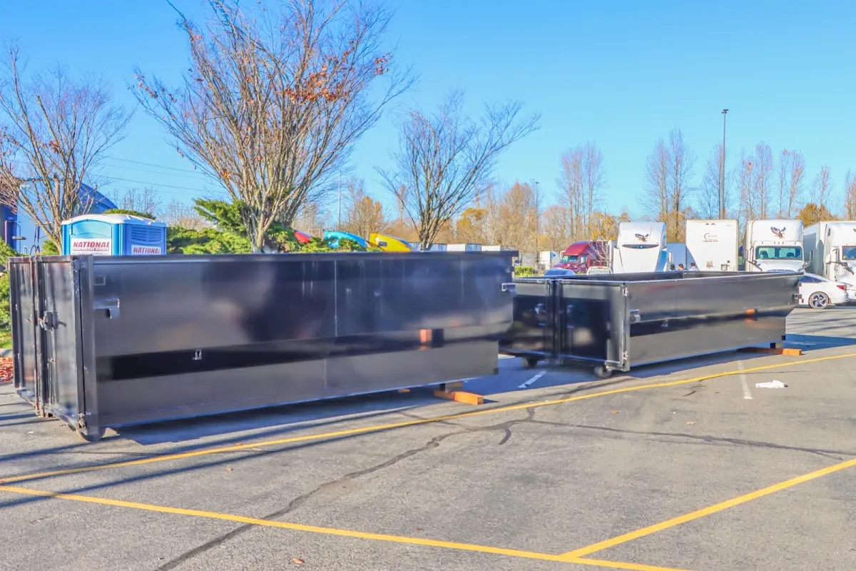 Professional dumpster rental service with roll-off container on residential driveway in Poinciana